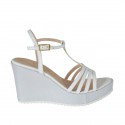 Woman's T-strap sandal in white patent leather and silver laminated fabric with platform and wedge heel 8