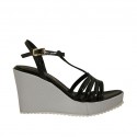 Woman's T-strap sandal in black patent leather and silver laminated fabric with platform and wedge heel 8