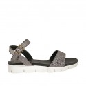 Woman's strap sandal in lead grey laminated leather with rocklike texture and wedge heel 2
